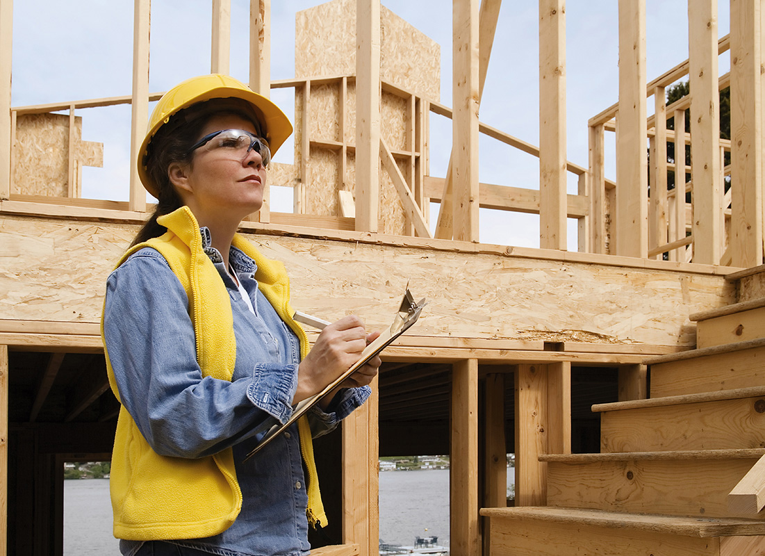 A construction woman taking notes